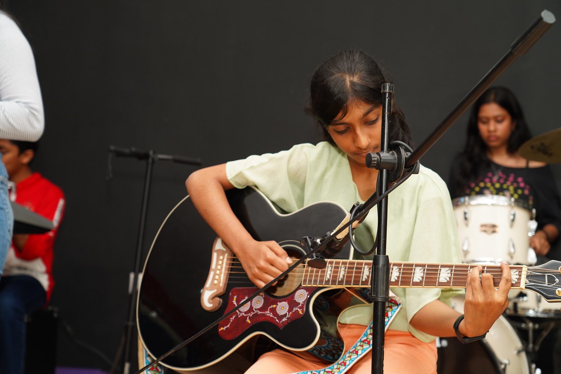 Young SARA Music School student performing on acoustic guitar