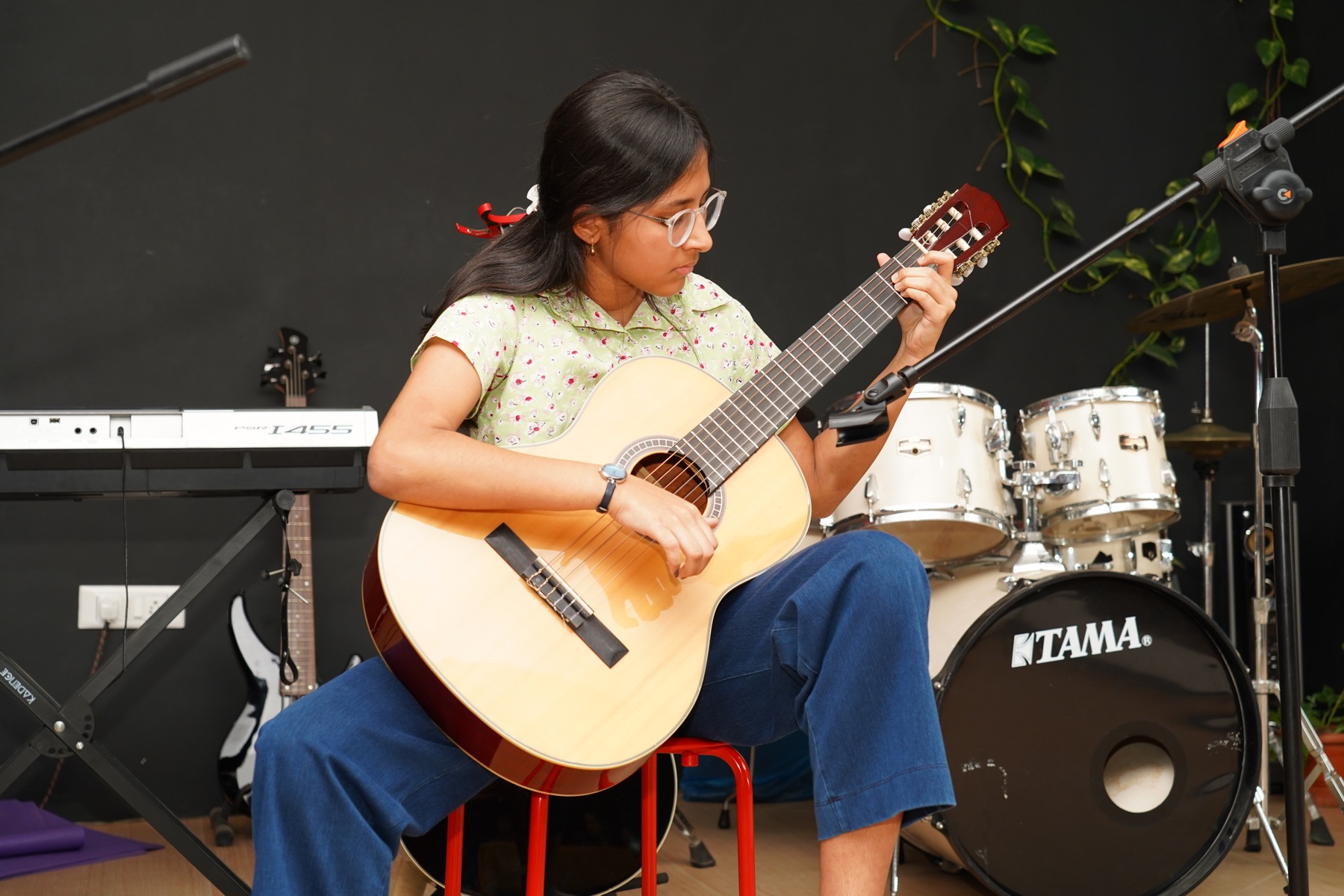 SARA Music School student performing classical guitar on stage