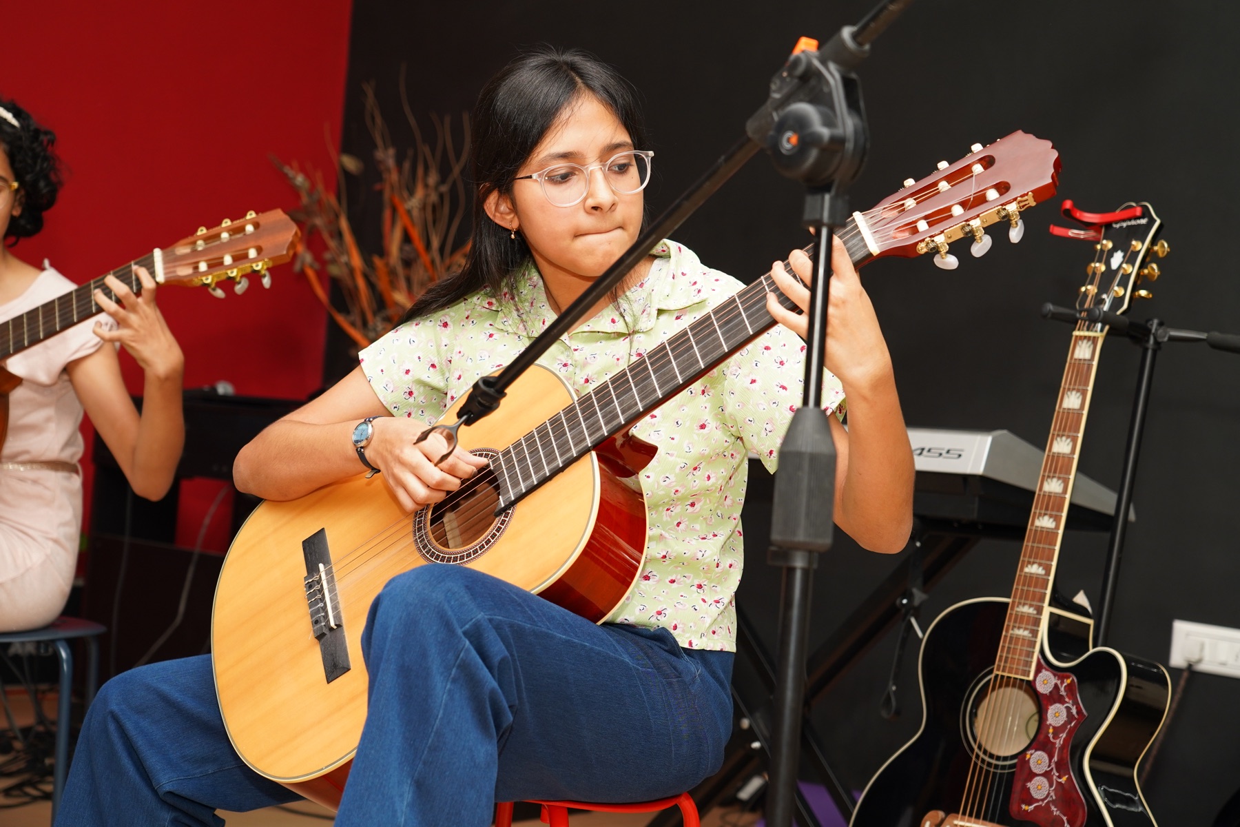 Young classical guitarist performing confidently at a SARA Music School event